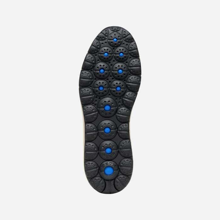 Black shoe outsole with a textured grip pattern and circular blue inserts.