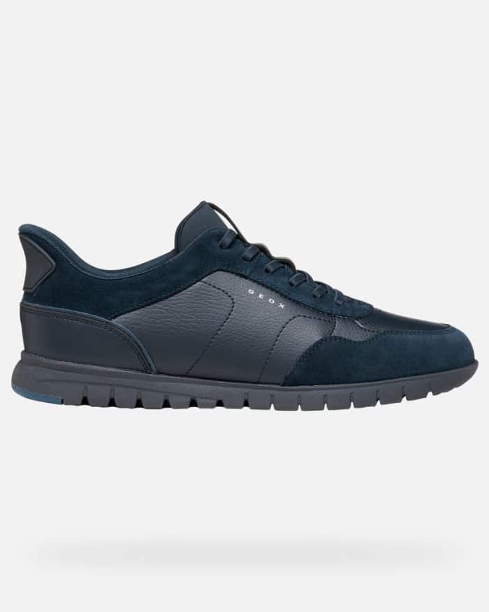 Navy blue Geox trainer with a textured leather and suede upper on a dark lugged sole.