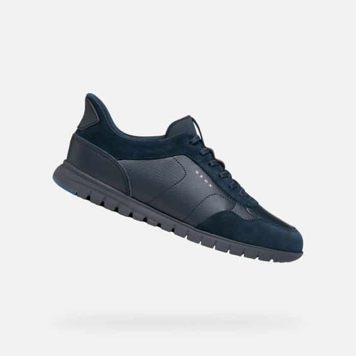 A dark navy blue trainer with a textured sole and the Geox logo on the side.
