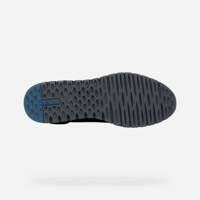 Bottom view of a grey trainer outsole with a blue heel insert featuring the Geox logo.