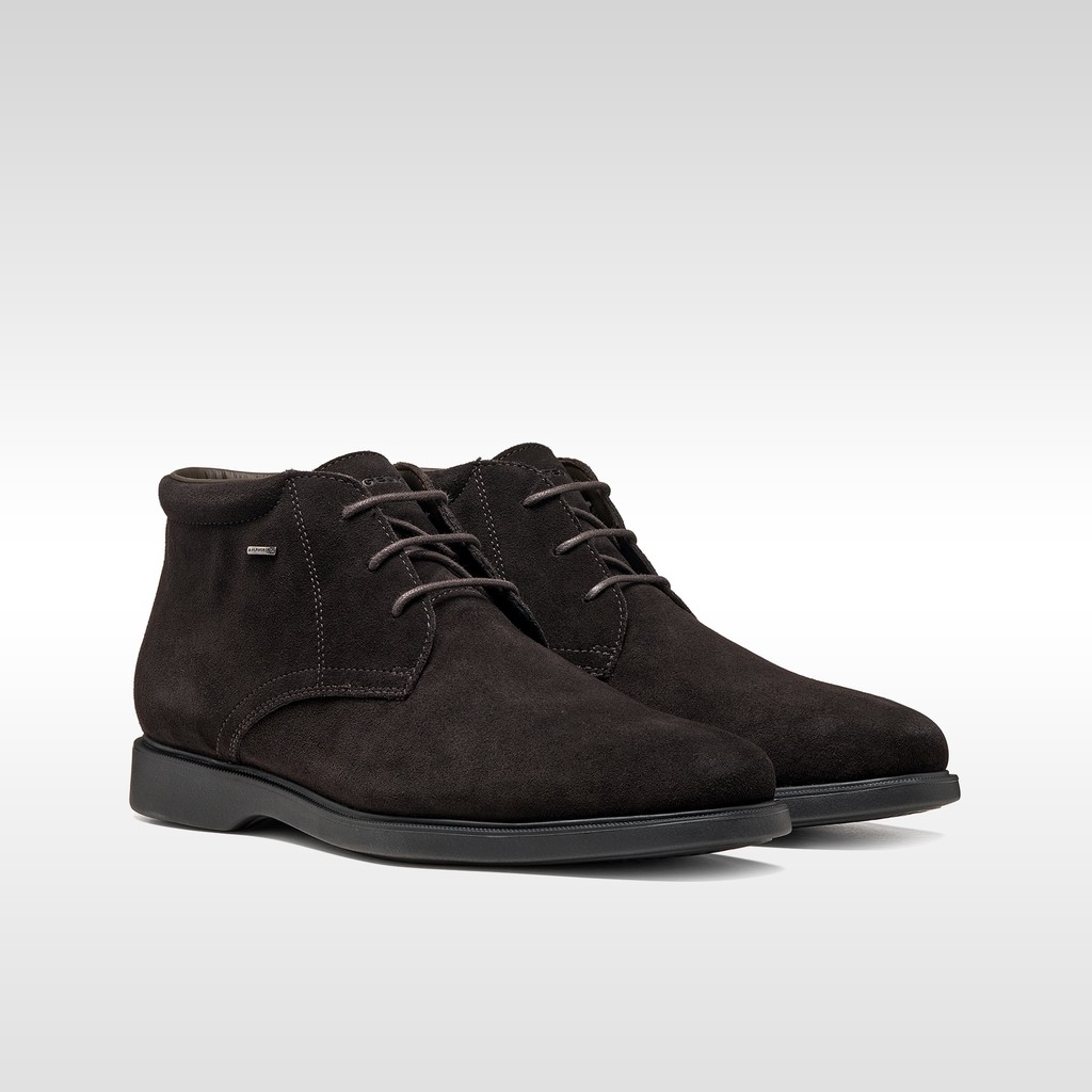 Dark brown suede chukka boots with matching laces and black rubber soles.