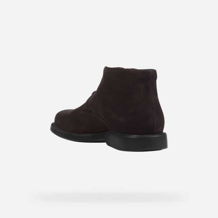 Dark brown suede ankle boot with a black sole, viewed from the side and back.