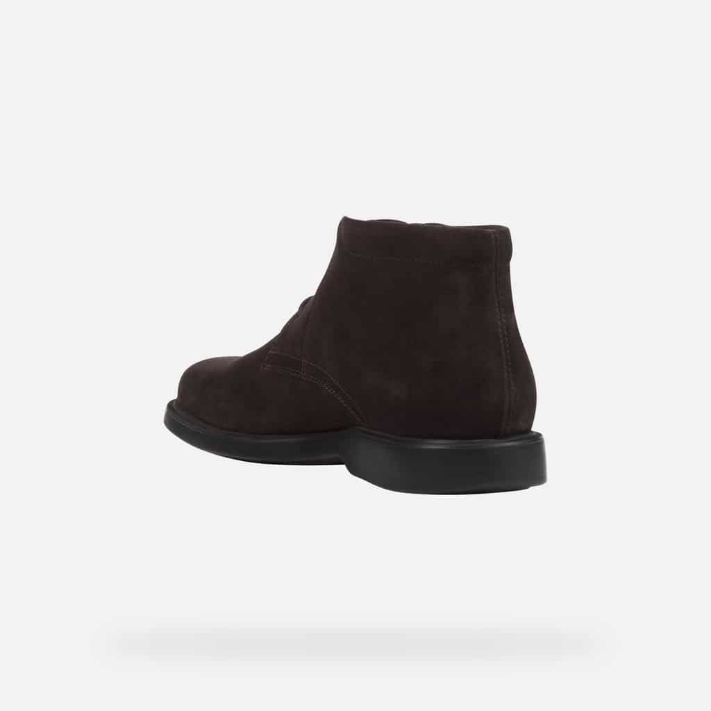 Dark brown suede ankle boot with a black sole, viewed from the side and back.