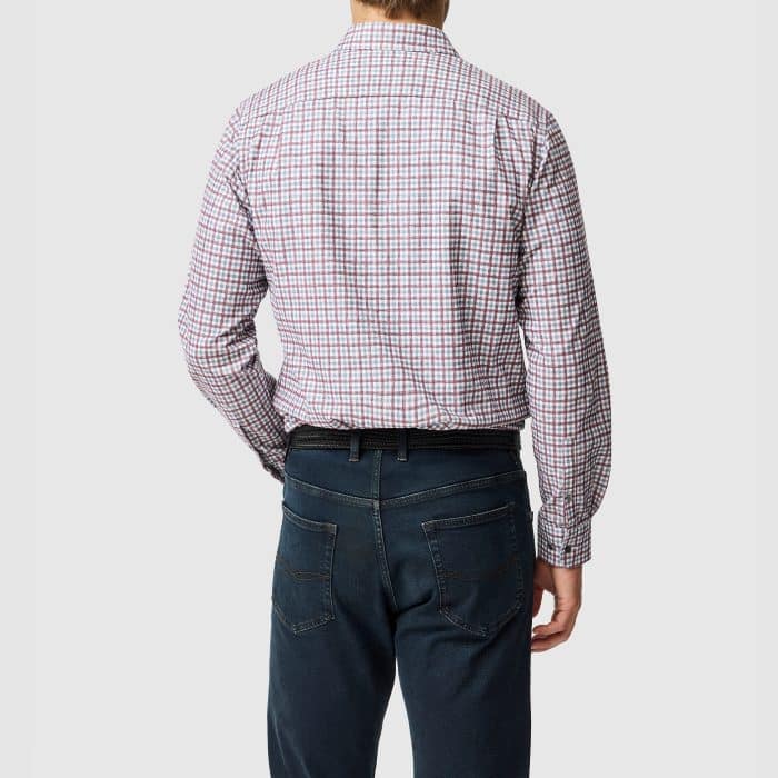 A man seen from behind wearing a red and blue checked button-up shirt tucked into dark blue jeans with a black belt.